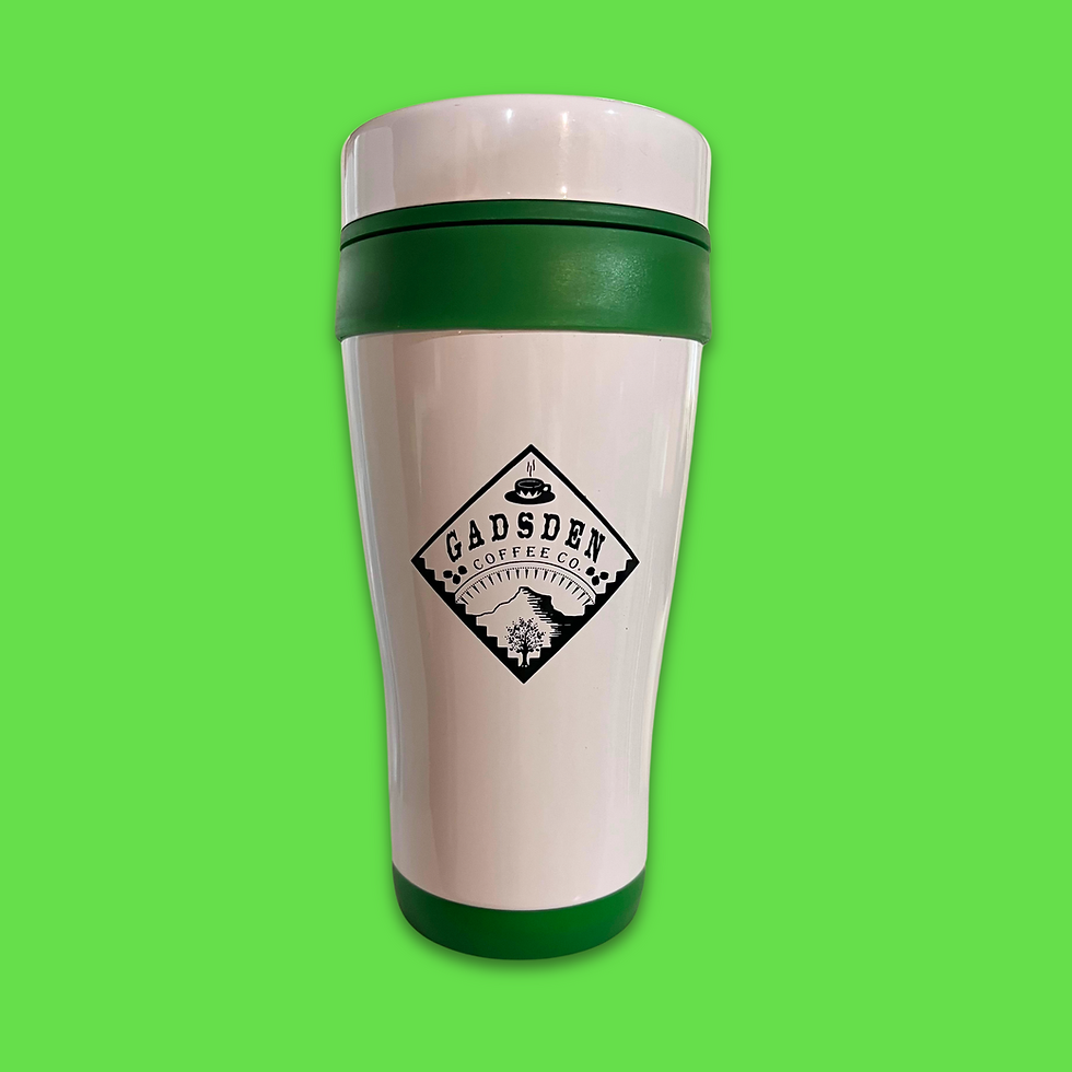 A green and white travel cup sits against a solid green background. On the cup is a black diamond shaped Gadsden Coffee Co. logo.