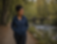 Woman walking beside a peaceful stream during outdoor therapy in New Jersey, supporting anxiety relief, emotional healing, mindfulness, and resilience.