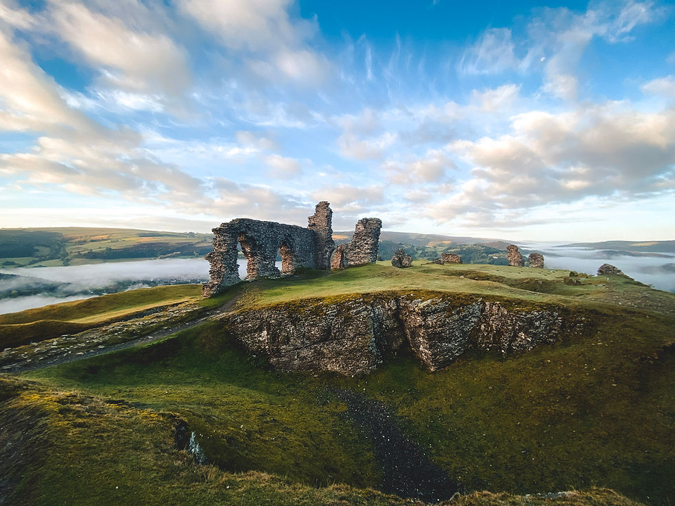 Castle ruins on a hilltop overlooking the town of Llangollen in Wales