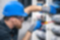 Male electrician working in a switchboard with fuses..jpg