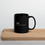 Thumbnail: 11 oz black ceramic mug with funny definition of a mutt, handle on right, sitting on wooden cutting board