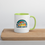 Thumbnail: White ceramic mug with green handle with stylized retro sunset graphic featuring a paw print and dog-themed wording