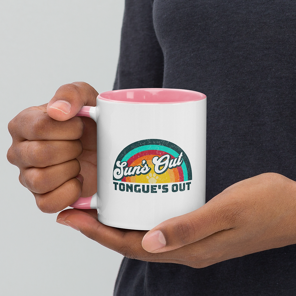 Thumbnail: Man's hands holding white ceramic mug with pink handle with stylized retro sunset graphic featuring a paw print