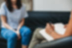 A psychiatrist writes notes for a patient in a mental health session