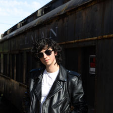 Jeremy Haney in a Leather Jacket, Standing in Front of a Train