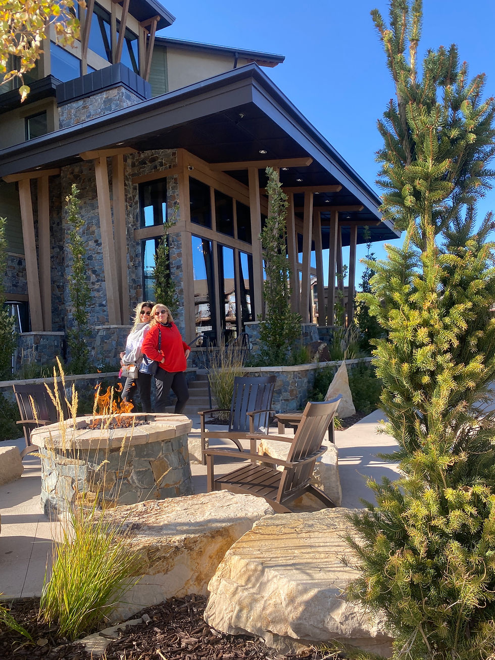 women standing by fireplace in front of Park City mountain hotel