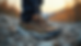 Close-up view of a pair of gorpcore sneakers on rocky terrain