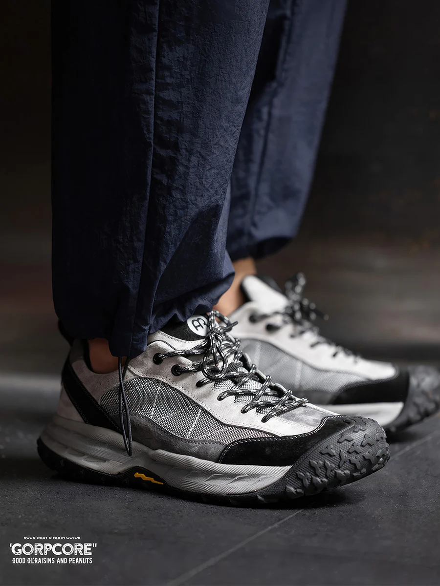 Person wearing grey and black trail shoes