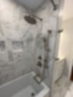 Carrara style porcelain tile tub surround with a double niche in a Scarsdale Fiberglass to tile surround makeover.