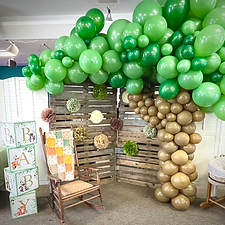 A phototbooth with a balloon tree wilderness themed