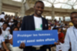 Man holding sign at Break the Silence launch, IRC, Côte d'Ivoire