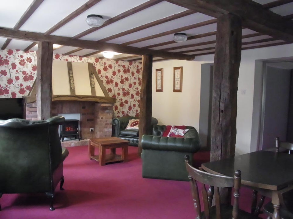 Apartment 1 Lounge with leather Chesterfields and feature electric fire. Two bedroomed apartment at Granary Court