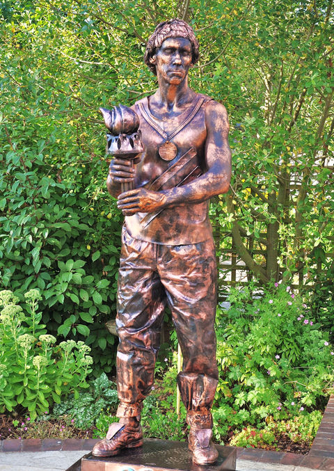 bronze olympian torch bearer living statue