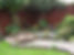 Flowing garden design with gravel area, quirky bridge, summer house and wildlife-friendly planting