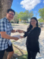 Man presenting a check to scholarship winner