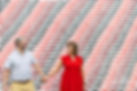 A couple on their Engagement Session in front of a mural - photographed by Sprinkle Creative