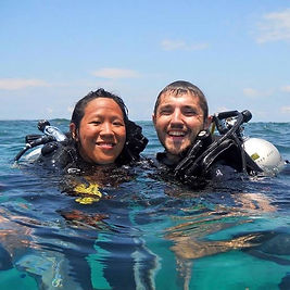 Two divers floating on the surface after an ocean dive
