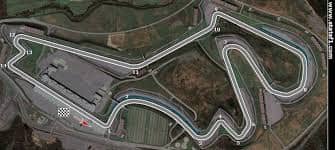 Satellite view of Istanbul Park showing the full Formula 1 circuit layout traced over the track, with the start finish area and multiple corners visible from above. The overhead perspective highlights the winding shape of the Istanbul race circuit and its surrounding service roads and runoff areas.