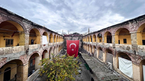 A traditional han courtyard inside the Grand Bazaar, decorated with a Turkish flag.