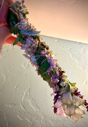 smudge stick with purple flowers and sage