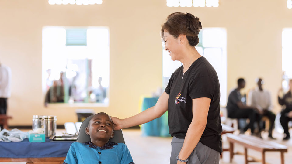 Lita offering support and comfort to a young patient at an outreach clinic