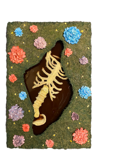 Mixed-media artwork featuring a sculpted skeletal spine and ribcage inside a dark cut out, surrounded by a mossy green surface decorated with colourful faux flowers.