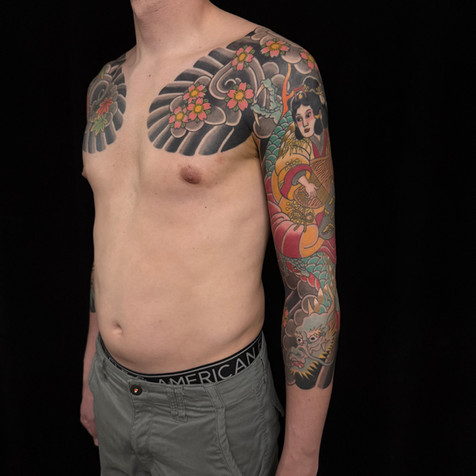 Benzaiten riding a dragon and sakura shichibu tattoo done by Alex del Rio at Golden Fudo, Japanese traditional tattoo shop in Munich Haidhausen.