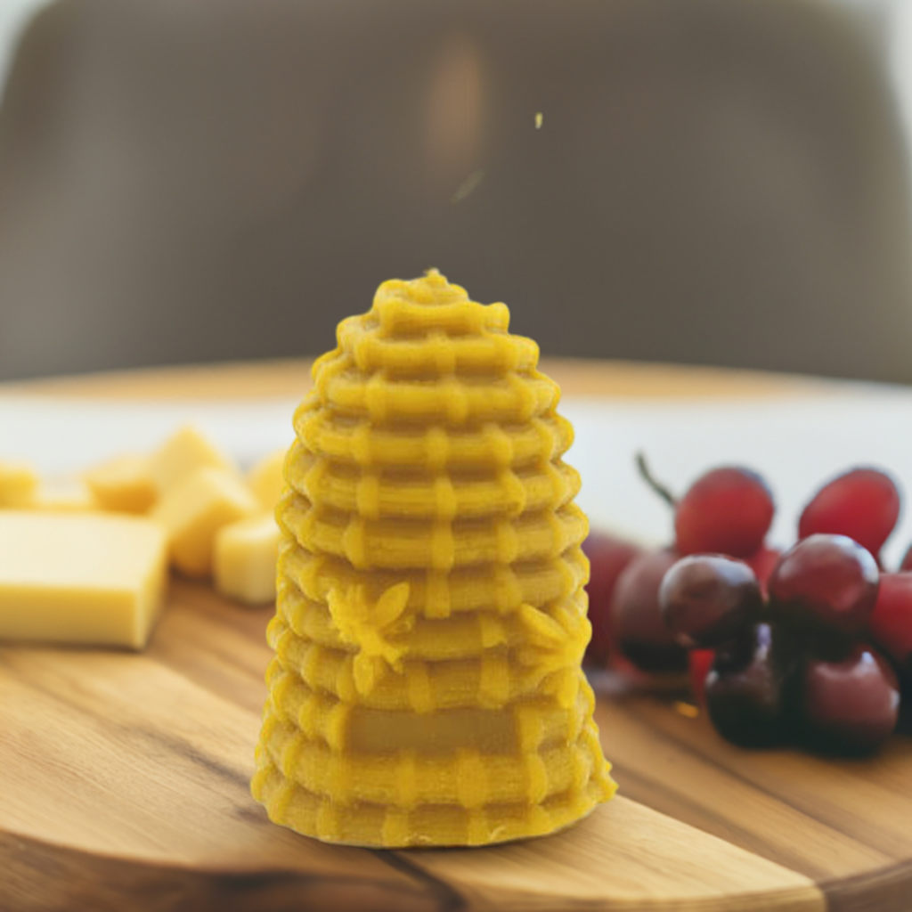 A Skep Beeswax Candle standing on a cheeseboard