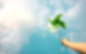ESG and Clean Energy Concept. Hand Raise up a Wind Turbine Paper into the Sky. Decrease Ca