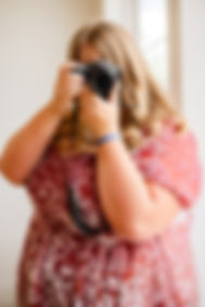 Woman in red dress taking photos with camera