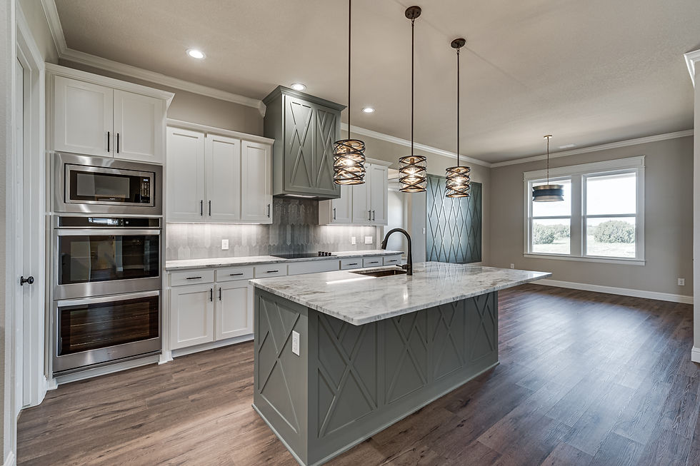 custom kitchen with large island, granite countertops and modern cabinetry in Texas home build