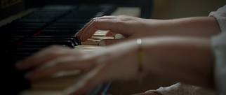 Close-up of hands playing piano keys