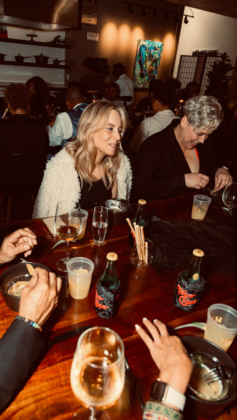 a woman sits at a table with a bottle of coca cola on it