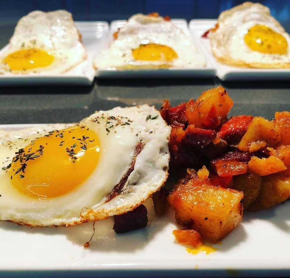 a plate of food with eggs and potatoes on it