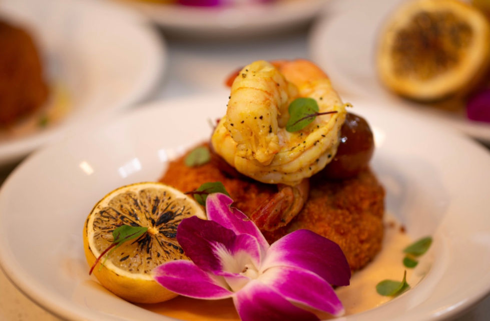 a plate of food with a purple flower on it