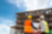 vecteezy_businessman-and-engineer-looking-at-a-building-blueprint-at_2439960.jpg