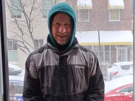 Dan Stamm stanidng in a doorway on a snowy day.