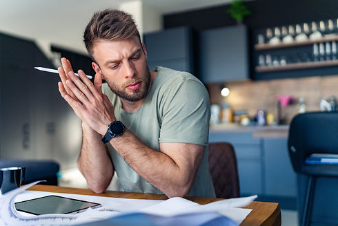 The business man looks thoughtfully at the papers on the table, something is not right.jpg