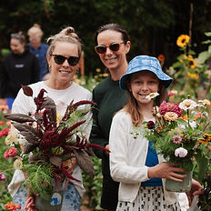 women holding bouquets of flowers