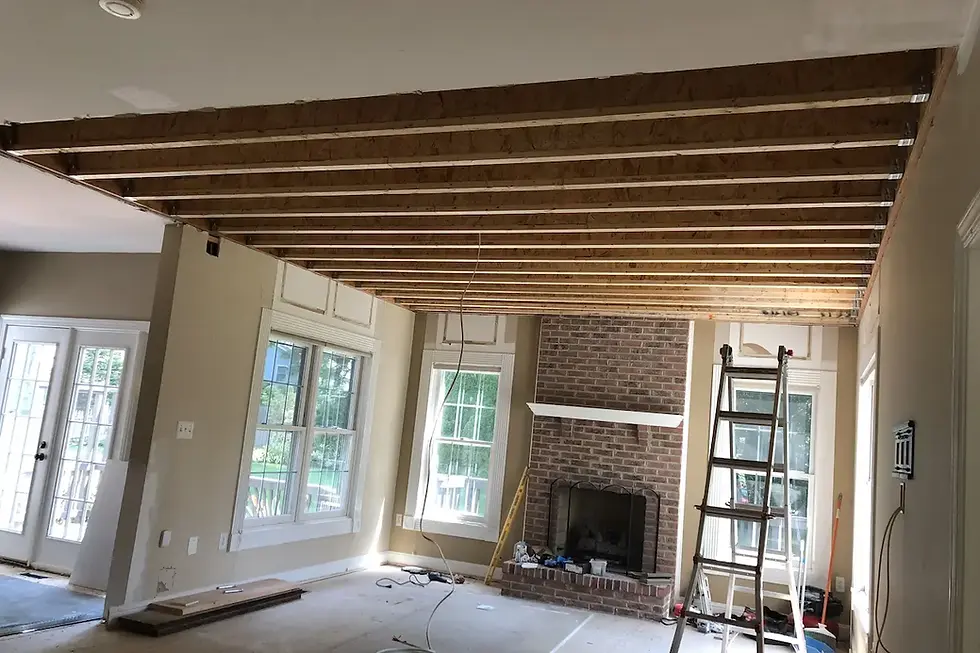 Vale Construction crew installing a structural beam during a two-story sunroom addition in the Alexandria area