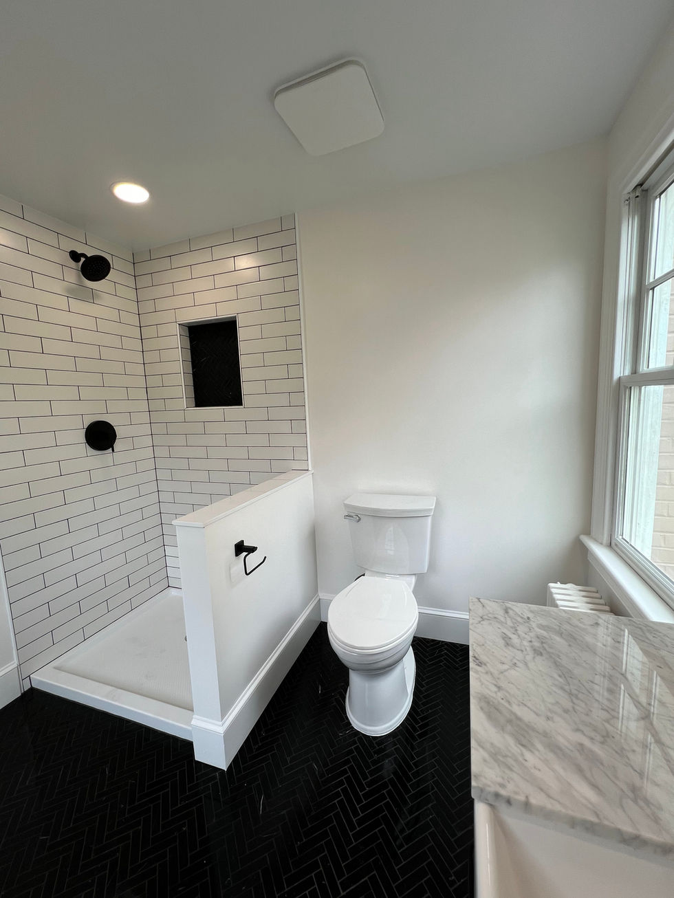 Farmhouse vanity with brushed hardware in a renovated historic bathroom