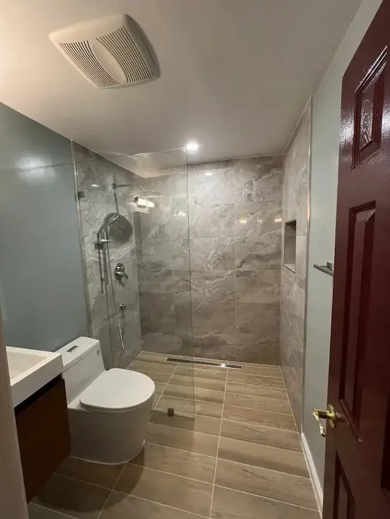 large format marble-look porcelain tile shower Alexandria VA — custom layout by Vale Construction