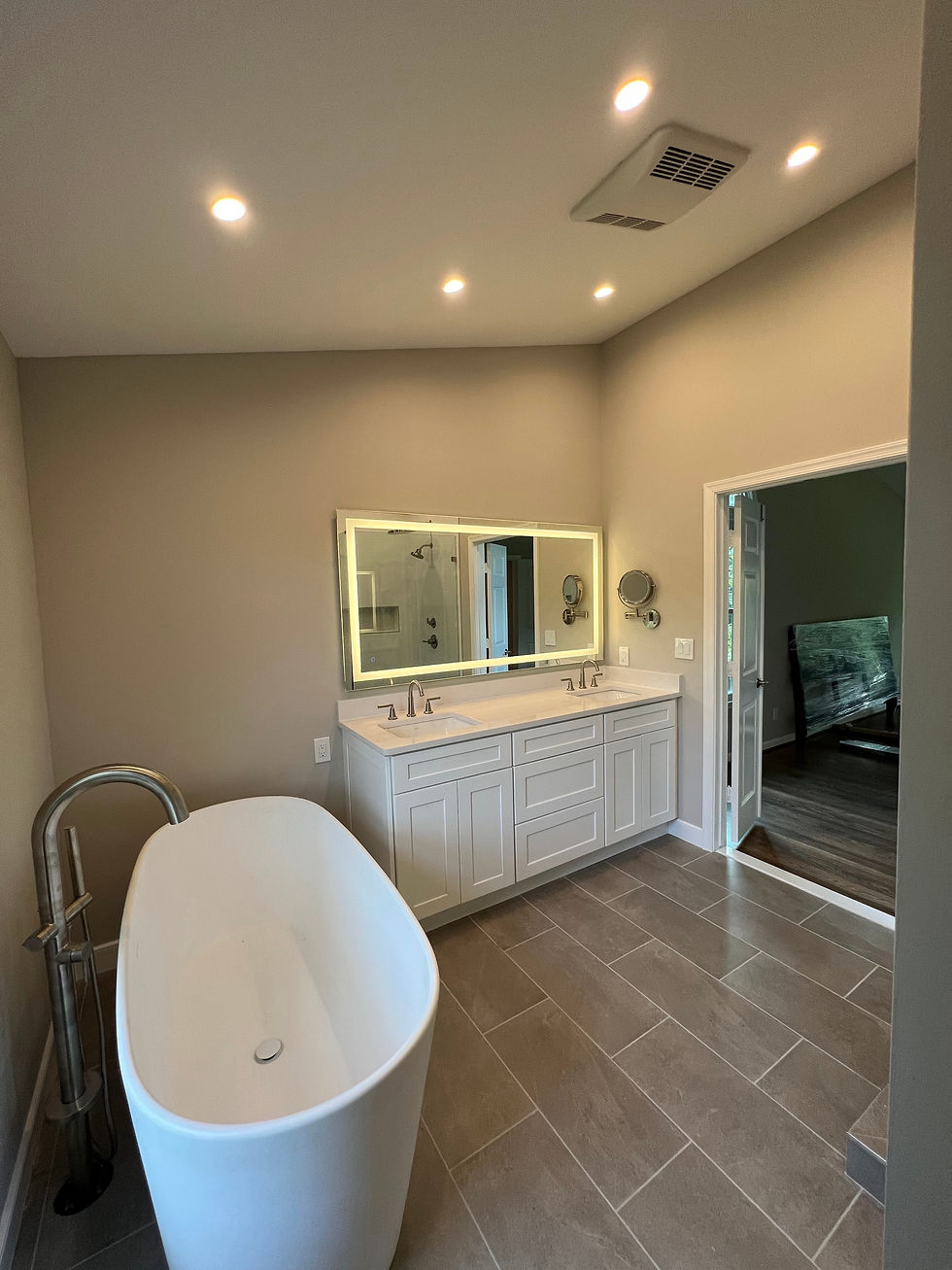 Primary bathroom remodel in Potomac MD with double vanity, quartz countertop, and freestanding soake