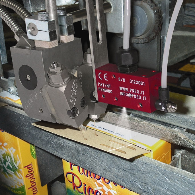 Protek adhesive application system applying glue to packaging