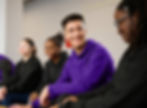 Smiling diverse students in purple hoodies