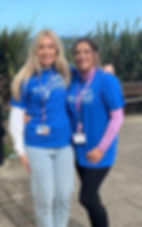 Two people with their arms around each other wearing blue harbour shirts.