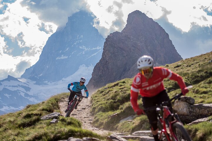 Mountain biking experience in Zermatt, Switzerland, with the iconic Matterhorn mountain prominent in the background.
