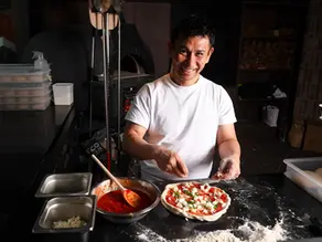 tamaki San sprays salt into the pizza