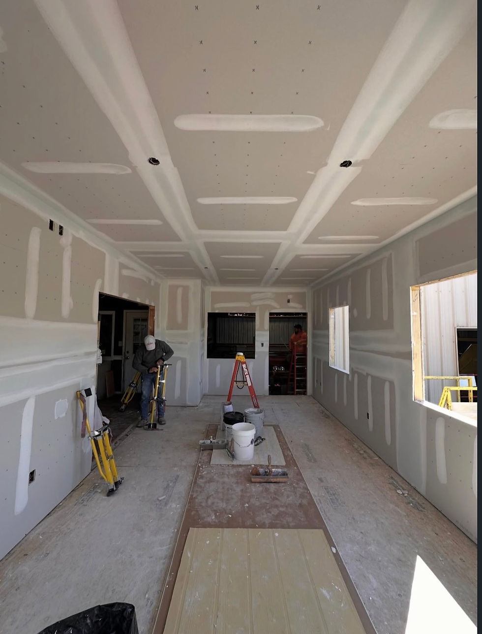New drywall installation in a room with coffered ceiling