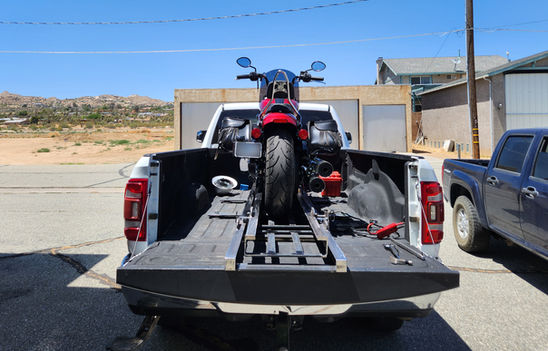 motorcycle truck bed loader system with bike secured on pickup rails